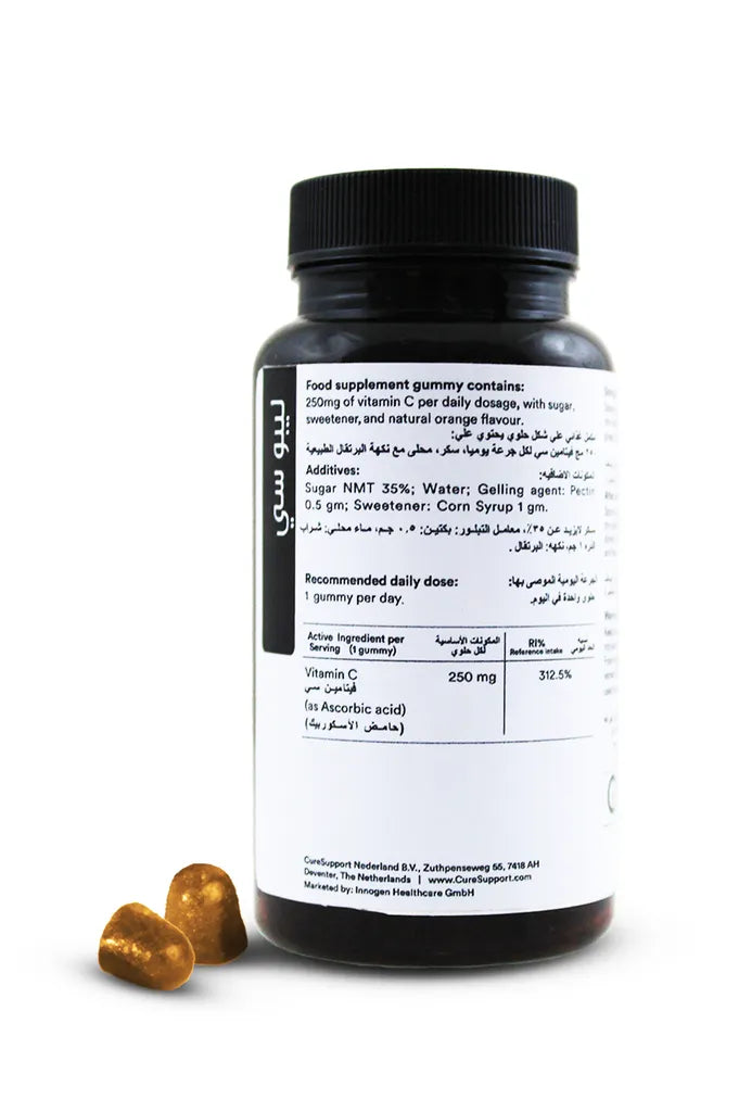 Supplement bottle with gold gummies on a white background