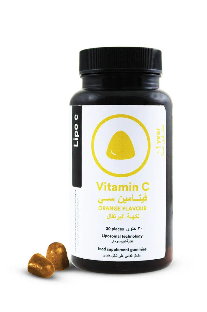 A bottle of Lipo C Vitamin C supplements with some gummies visible in front of the bottle. The label is predominantly white with a yellow logo and text.